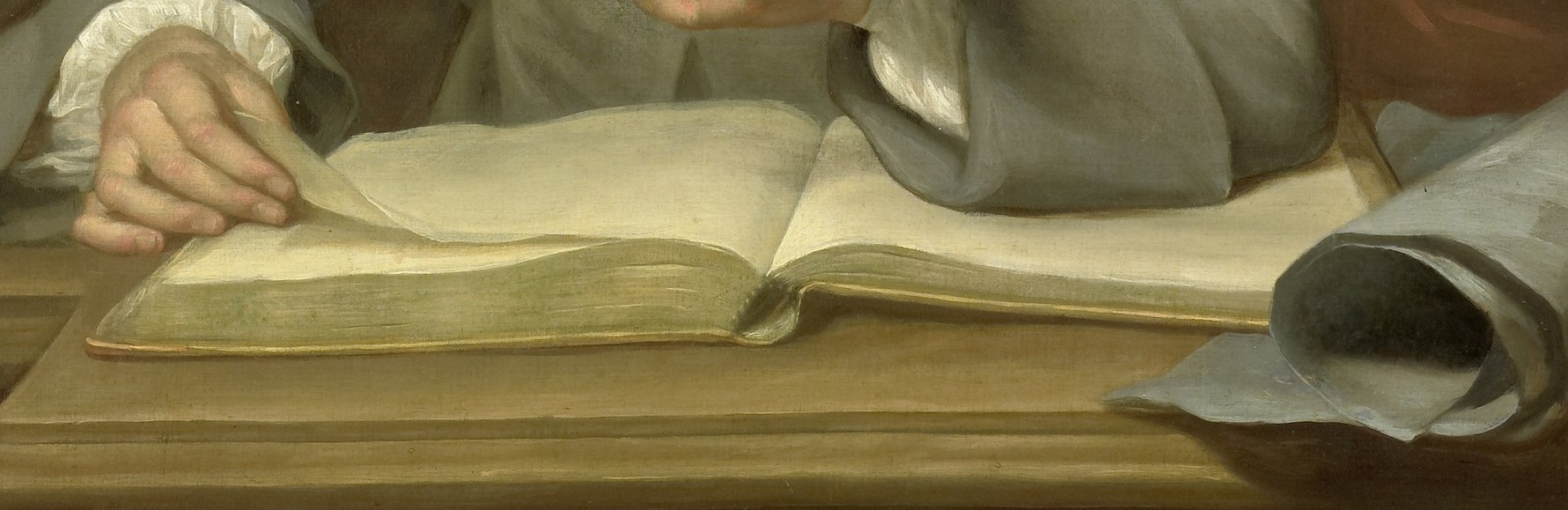 His hands also rest on a prominent open book.