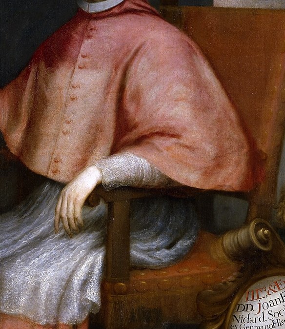 His red robes signify high ecclesiastical rank and authority.