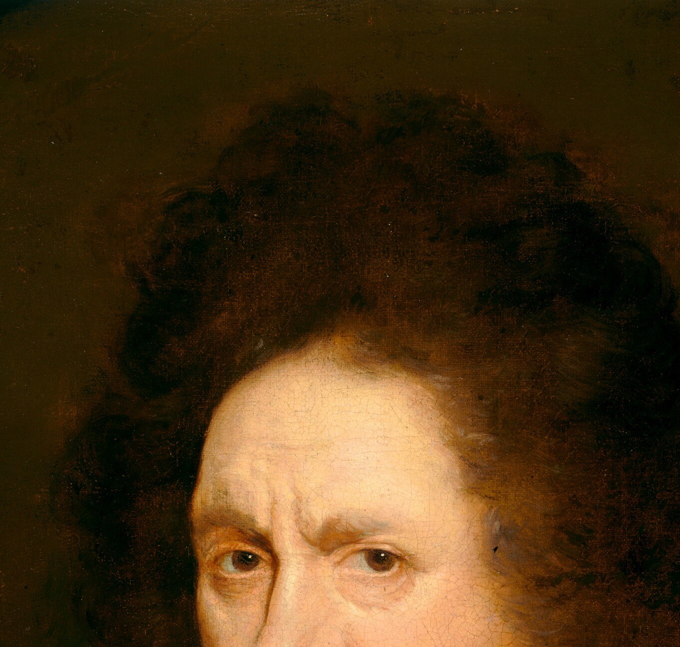 This man looks straight at you, unsmiling.