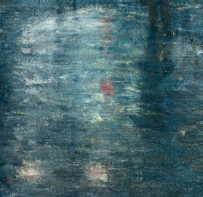 Street lamps glow on wet pavement.