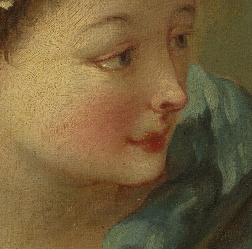 Her soft features and downward gaze suggest introspection and a gentle demeanor.