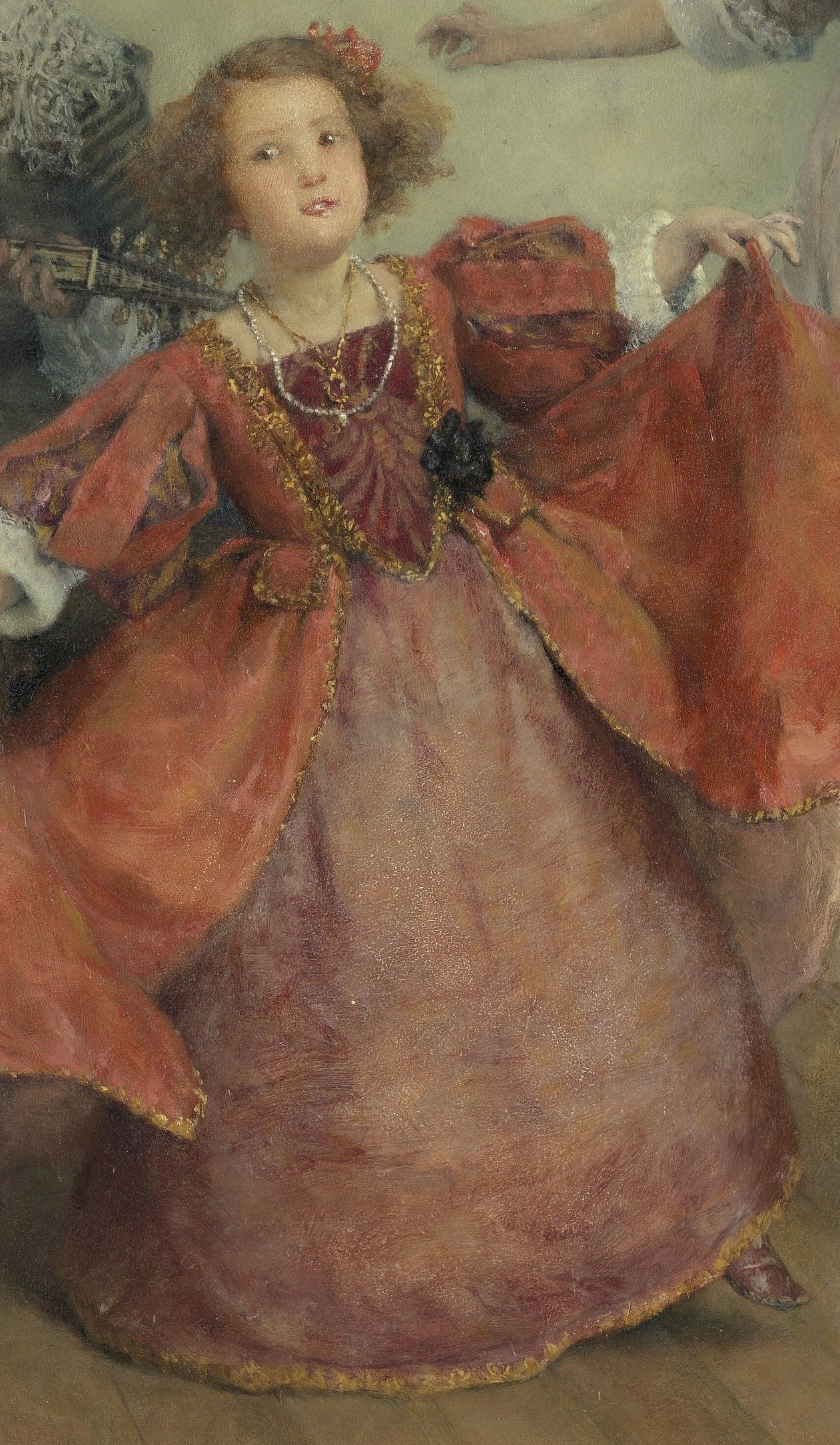 A young girl in red practices a dance or a graceful pose.