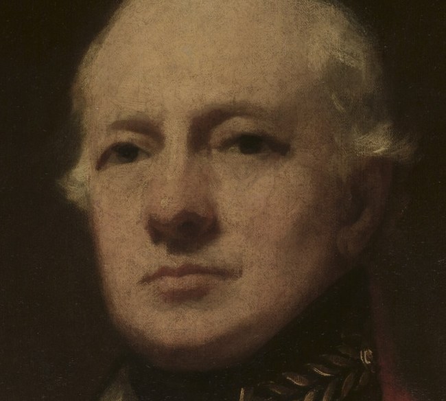 His steady gaze and upright posture convey his sense of duty.