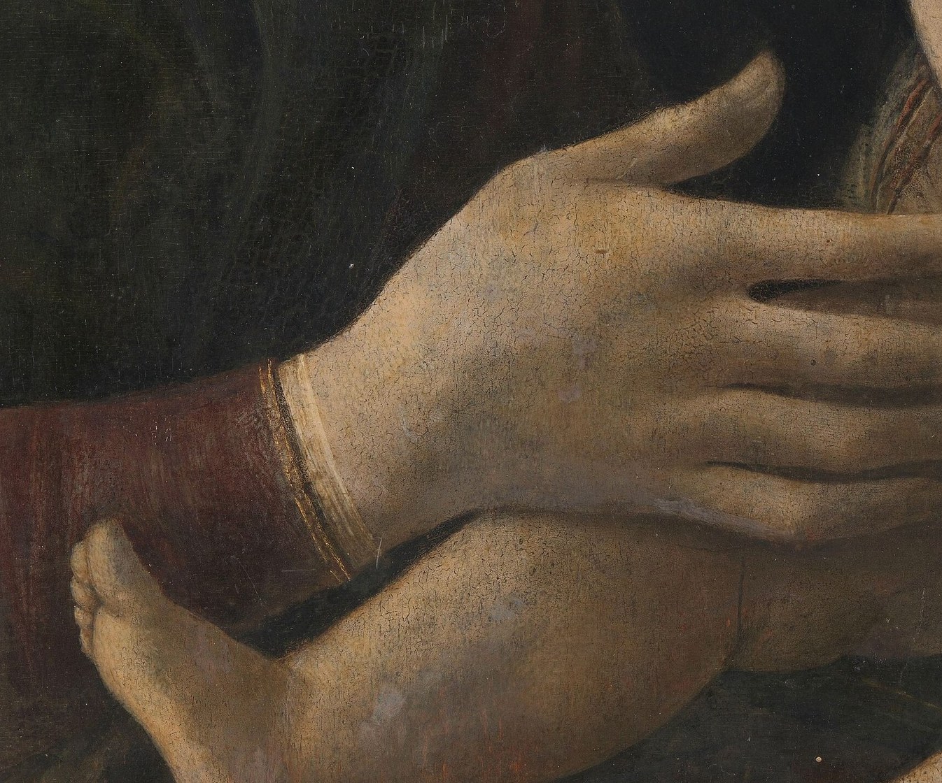 Her hands hold the child with quiet tenderness.