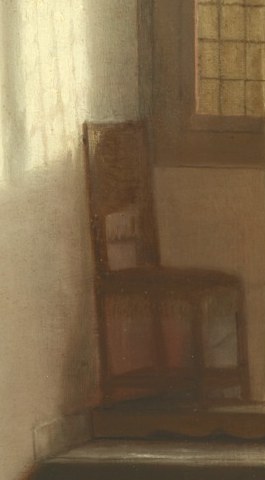 An empty chair sits in the light.