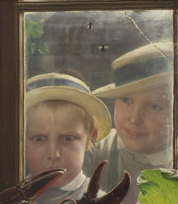 A boy in a straw hat leans into the frame.