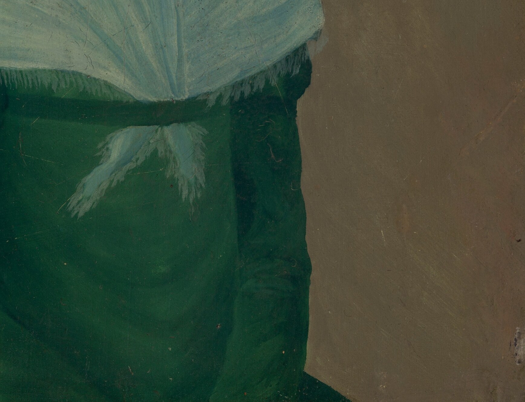 Her green dress and ornate chair suggest comfort and status.