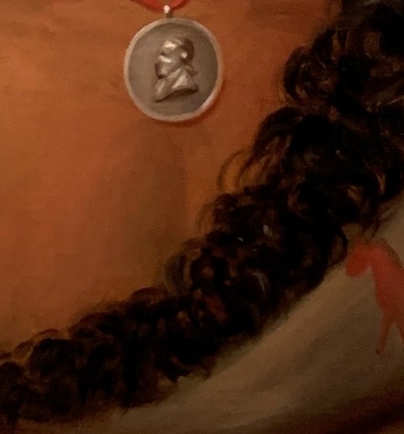 Then look at the medal on his chest.