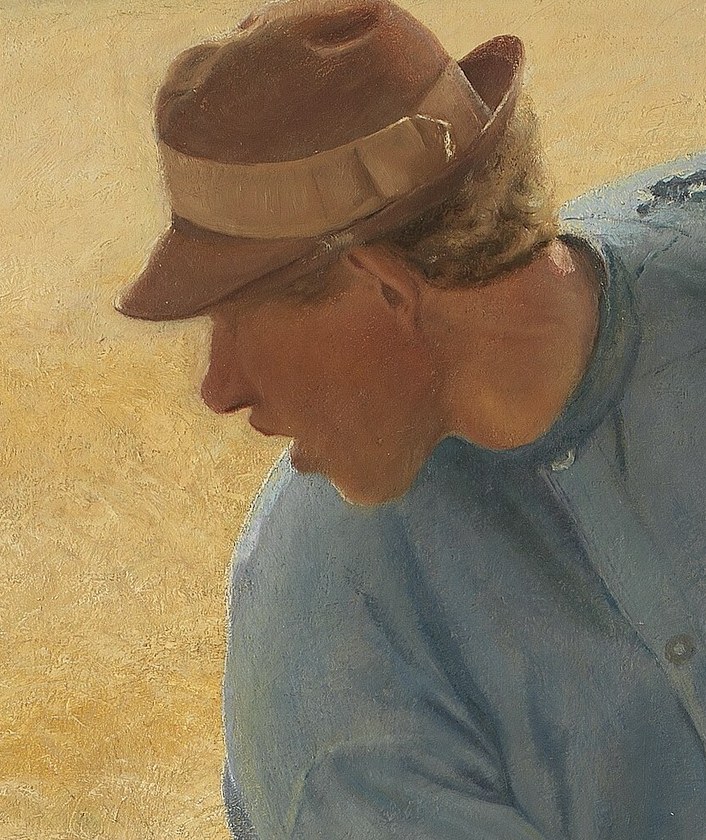 The farmer pauses his work for a moment.