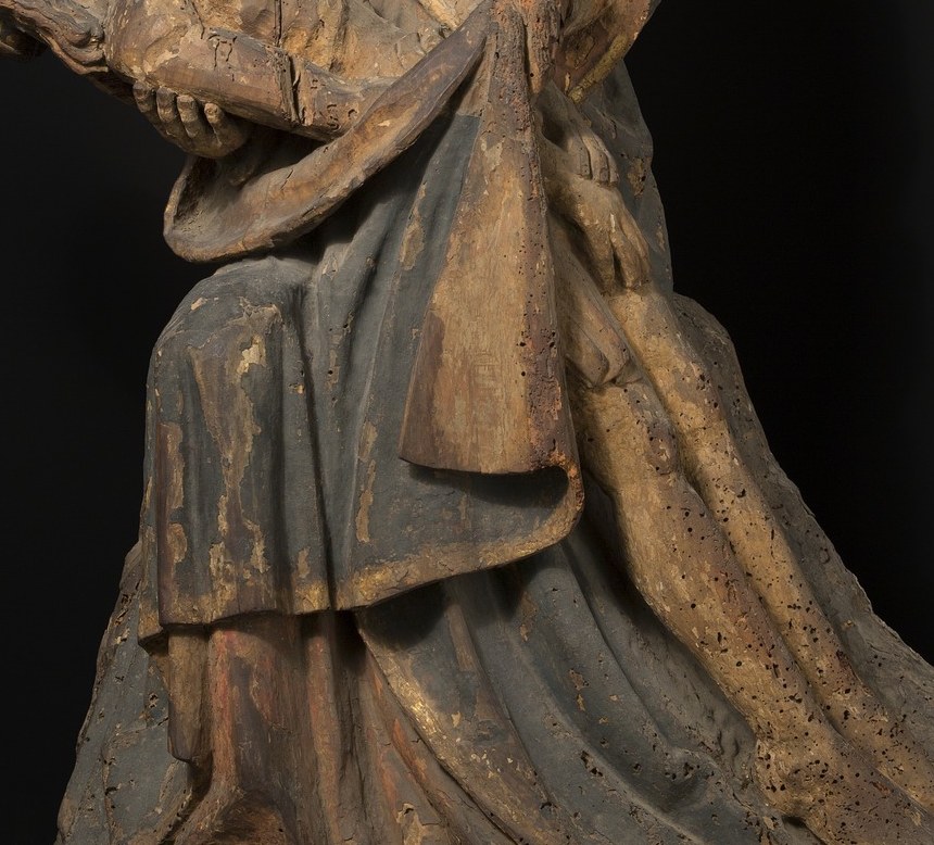 That glint is gold leaf. The whole sculpture was once painted.