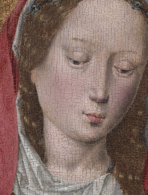 Her gaze is soft, her eyes cast down.