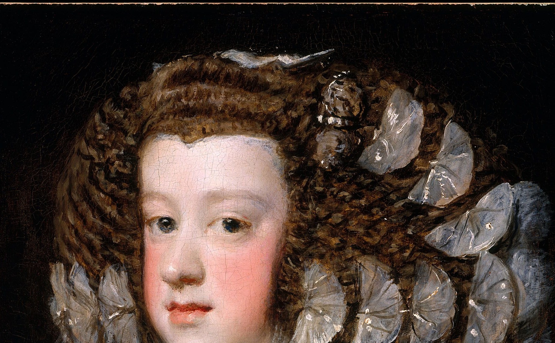 Dominates two-thirds of the canvas; the loose, almost impressionistic brushwork in the curls is Velázquez at his most technically daring