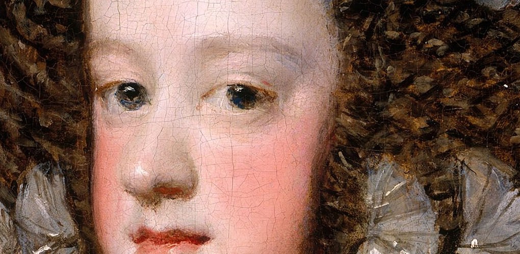 Her cheeks are flushed with a rouge she did not choose.