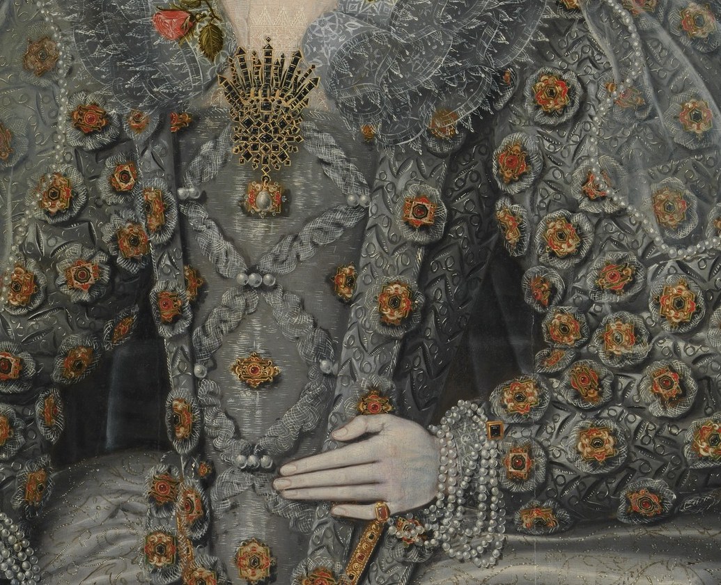 Dozens of enameled or jeweled roundels arranged in a grid across the bodice and skirt , a documented fashion of ca. 1600 English court dress that places this sitter precisely in time and social tier.
