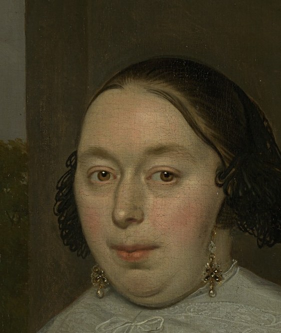 A woman in a garden. She meets your eye.