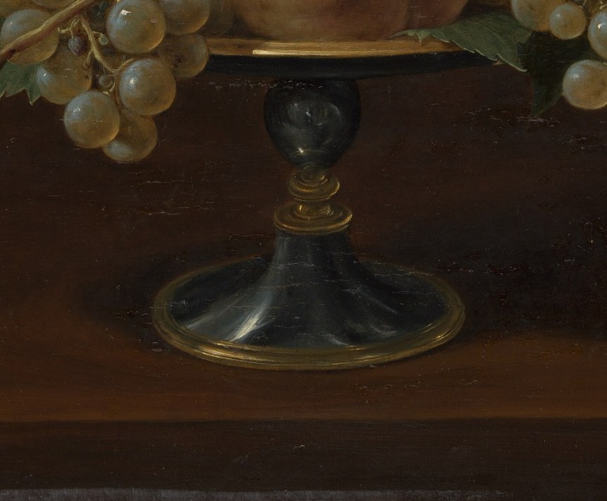 Now look closer at the glass goblet holding the fruit.
