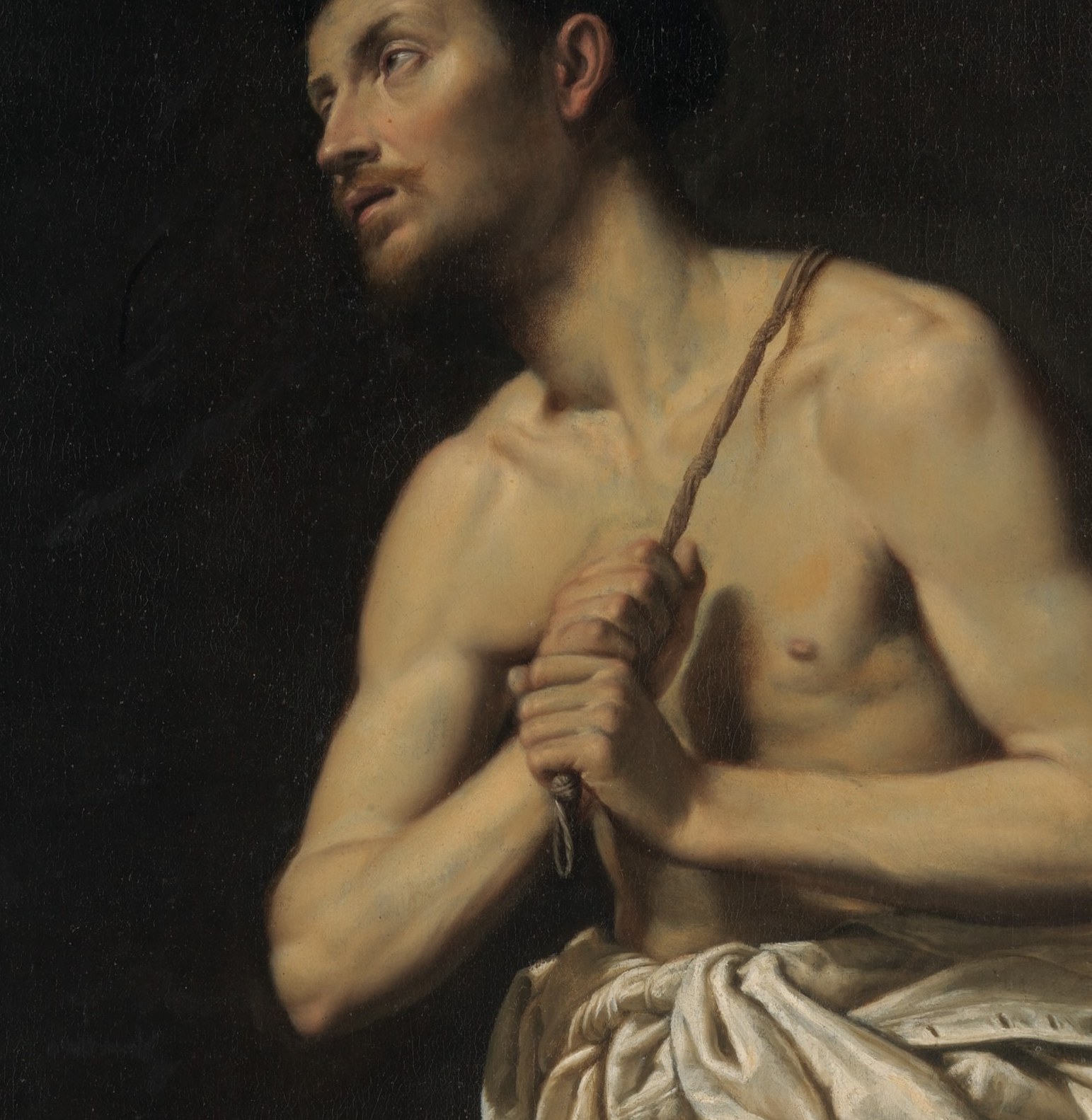The exposed flesh against white drapery dramatizes vulnerability and penitential humility; the skin catches the primary light source