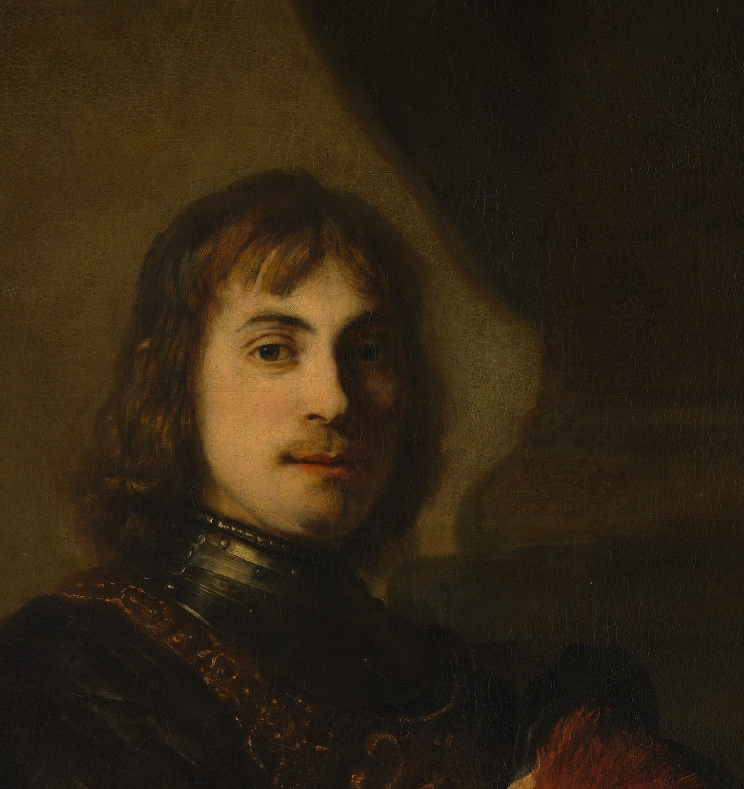 The sitter's face emerges from total darkness.