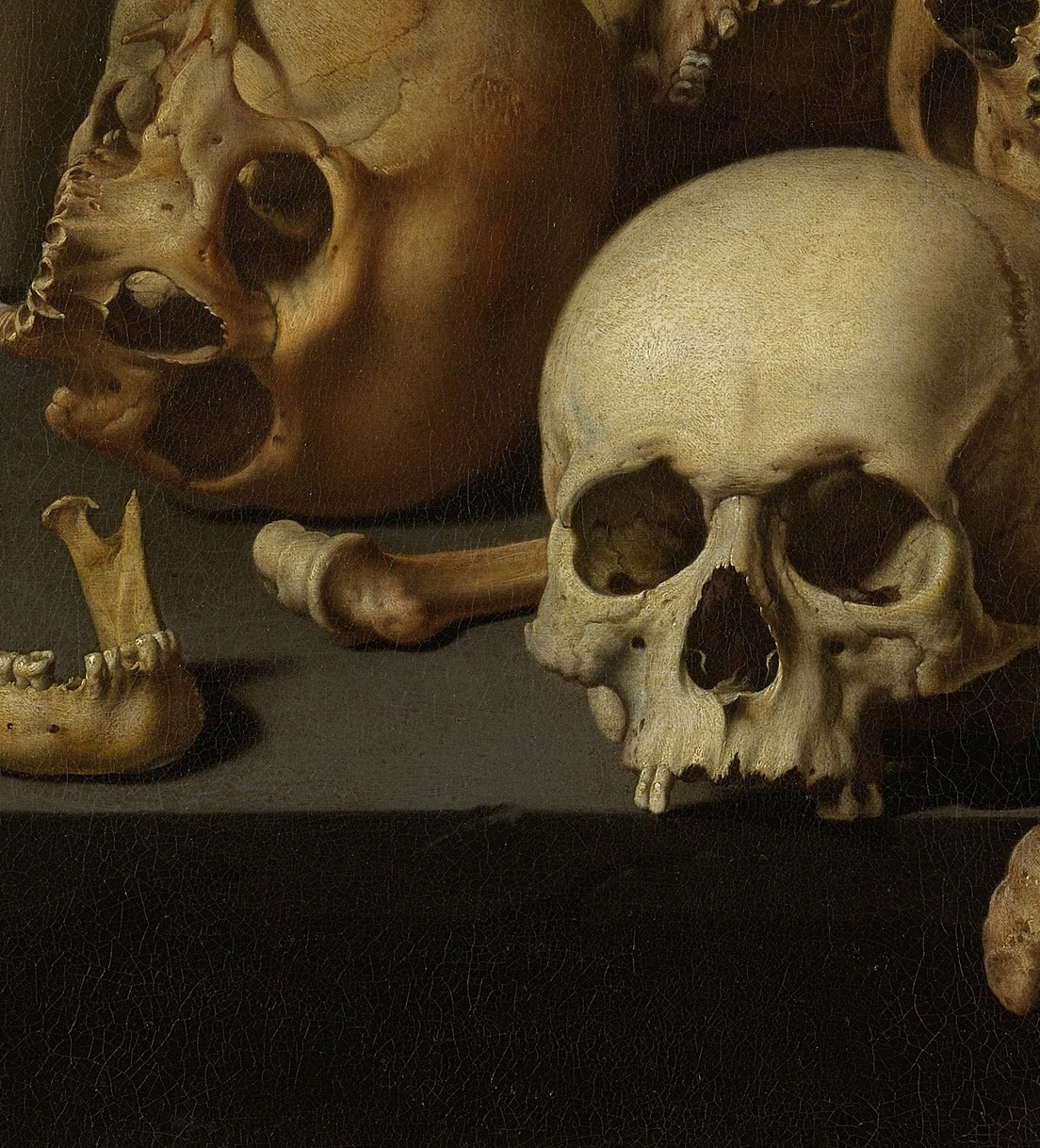 So the skulls face the viewer. But a small red object pushes back.
