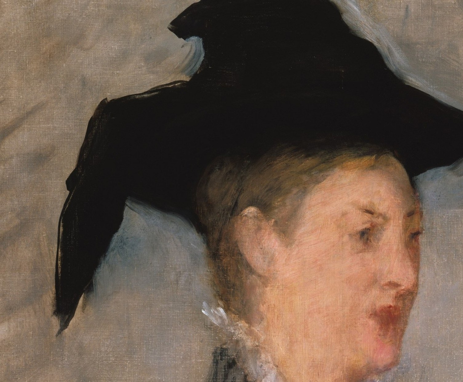 The dramatic silhouette of the hat frames her face and adds a touch of fashionable formality.