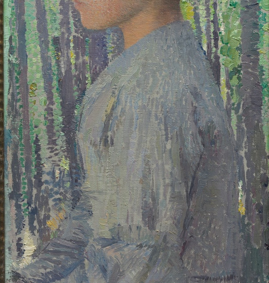 Her light attire contrasts with the deep greens of the forest.