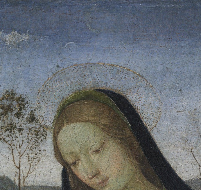 She prays. Her eyes are closed to the world.