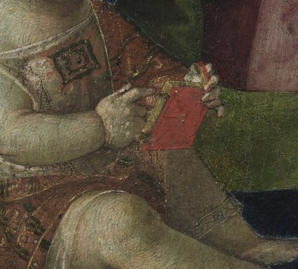 In his hands, a red carnation.
