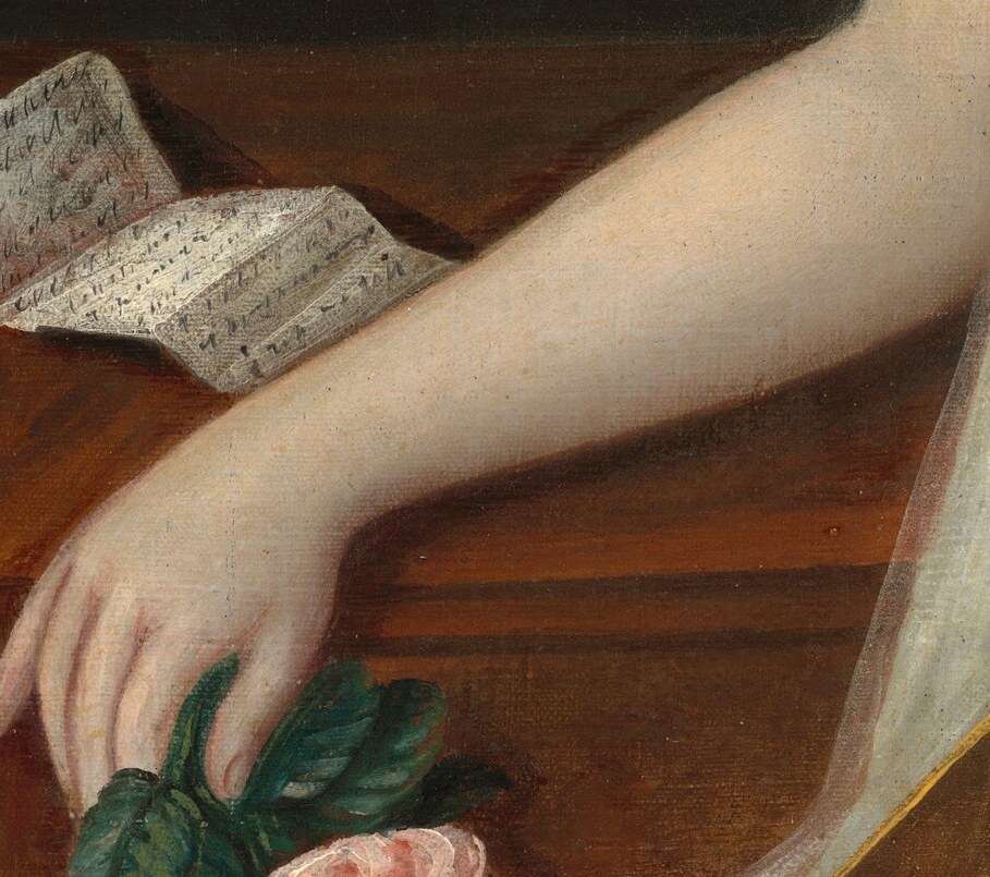 And the rose in her hand means innocence, but also transience.