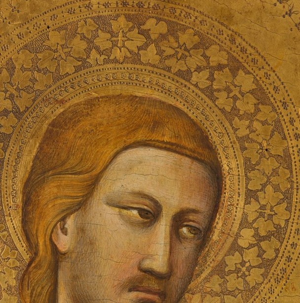 He stands calm, young, and gold-crowned.