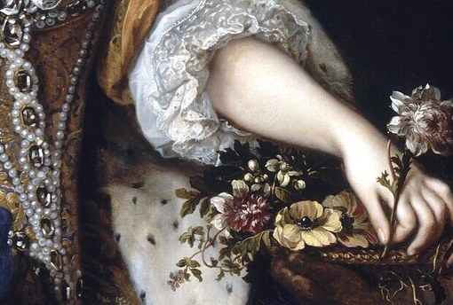 Her gown alone, with its gold embroidery, proclaims her wealth.