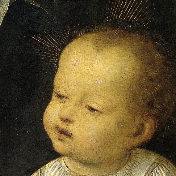 The child looks bewildered, but holds his rosary.