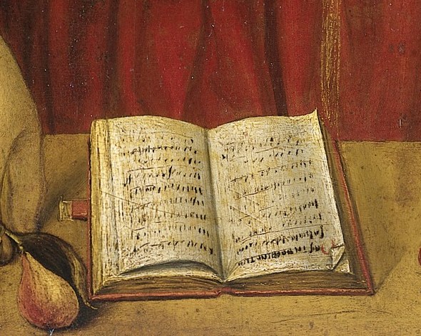 Musical notation is visible in the open book.