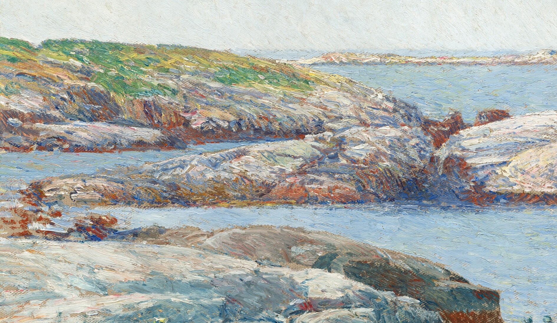 The textured rocks, bathed in light, provide a sense of place and the ruggedness of the coastal landscape.