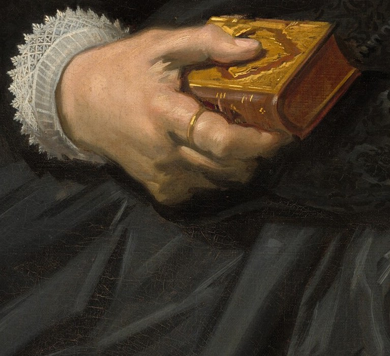 Her hands, relaxed and natural, hold a small, gold-clasped book.