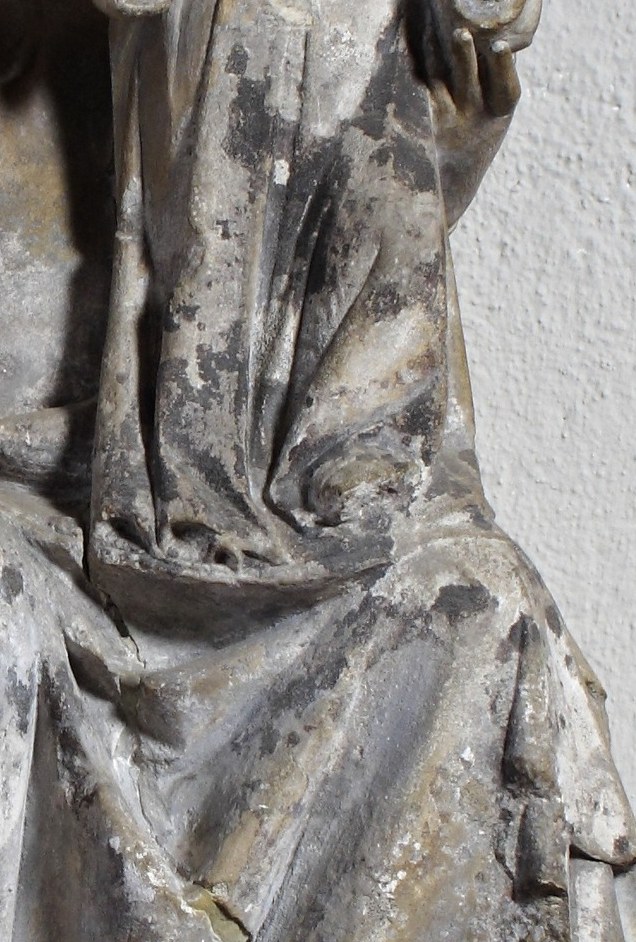 The way the child is nestled against the mother's form suggests a deep maternal connection and protection.