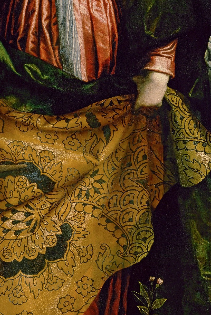 Look at the elaborate patterns on the donor's cloak.