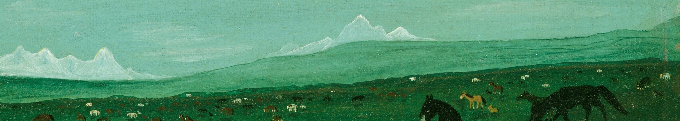 Distant mountains touch the pale blue sky.