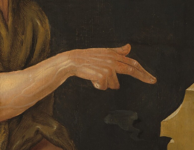 Young John the Baptist points, as if to say, 'Look.'
