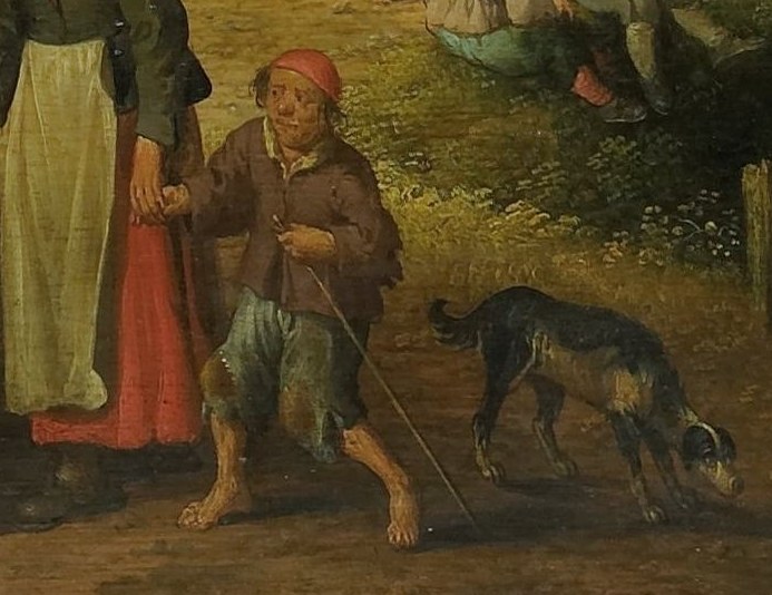 A boy in a red shirt walks his dog by the water's edge.