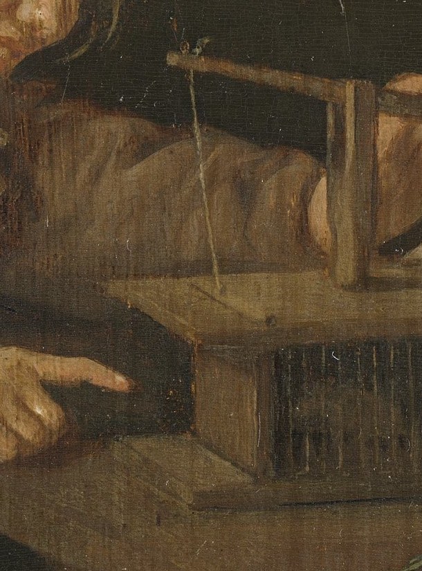 Wood grain, string, a simple spring. Painted to convince.