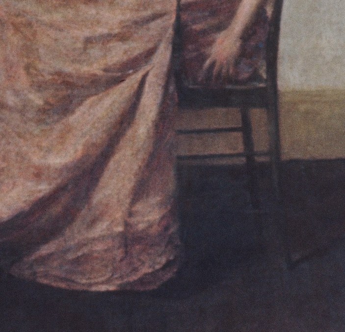 Her delicate pink dress adds a touch of luxury.