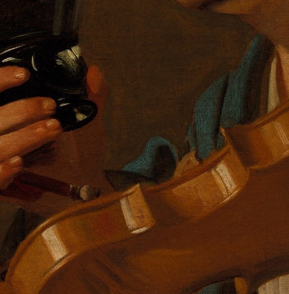 His violin is still. He has paused to drink.