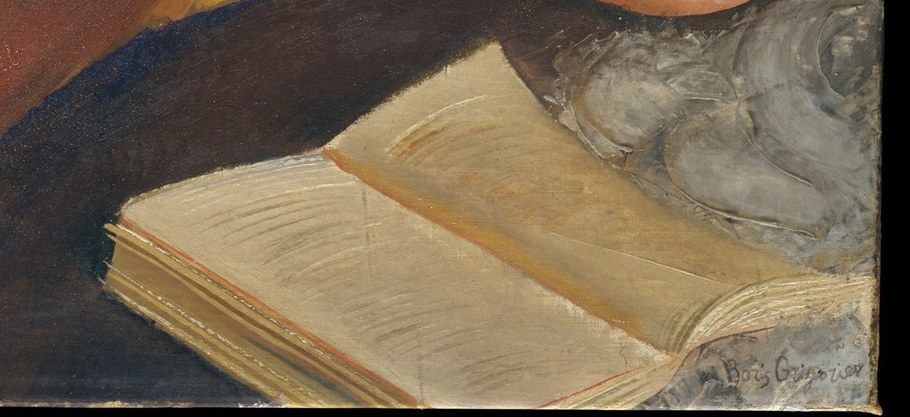 This woman reads, absorbed in her book.