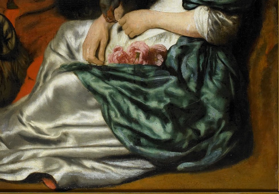 The young woman wears white. Her dress fabric shimmers.