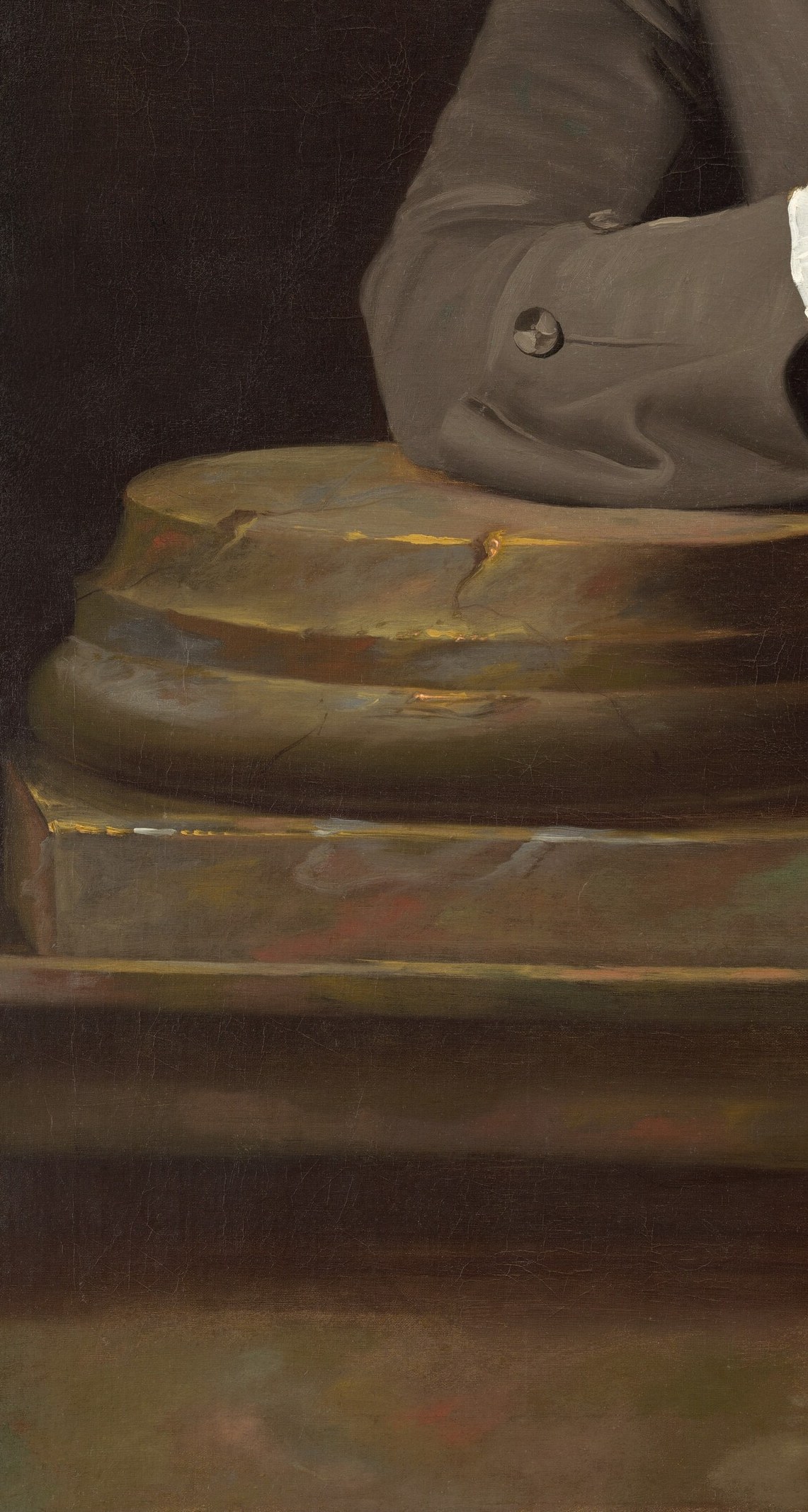 A deliberate prop borrowed from British portraiture to signal permanence, education, and classical taste; the rough-hewn stone surface provides a dramatic textural counterpoint to fine fabric.