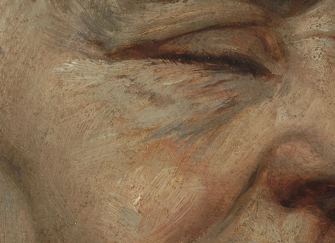 Deep wrinkles line her nose bridge.