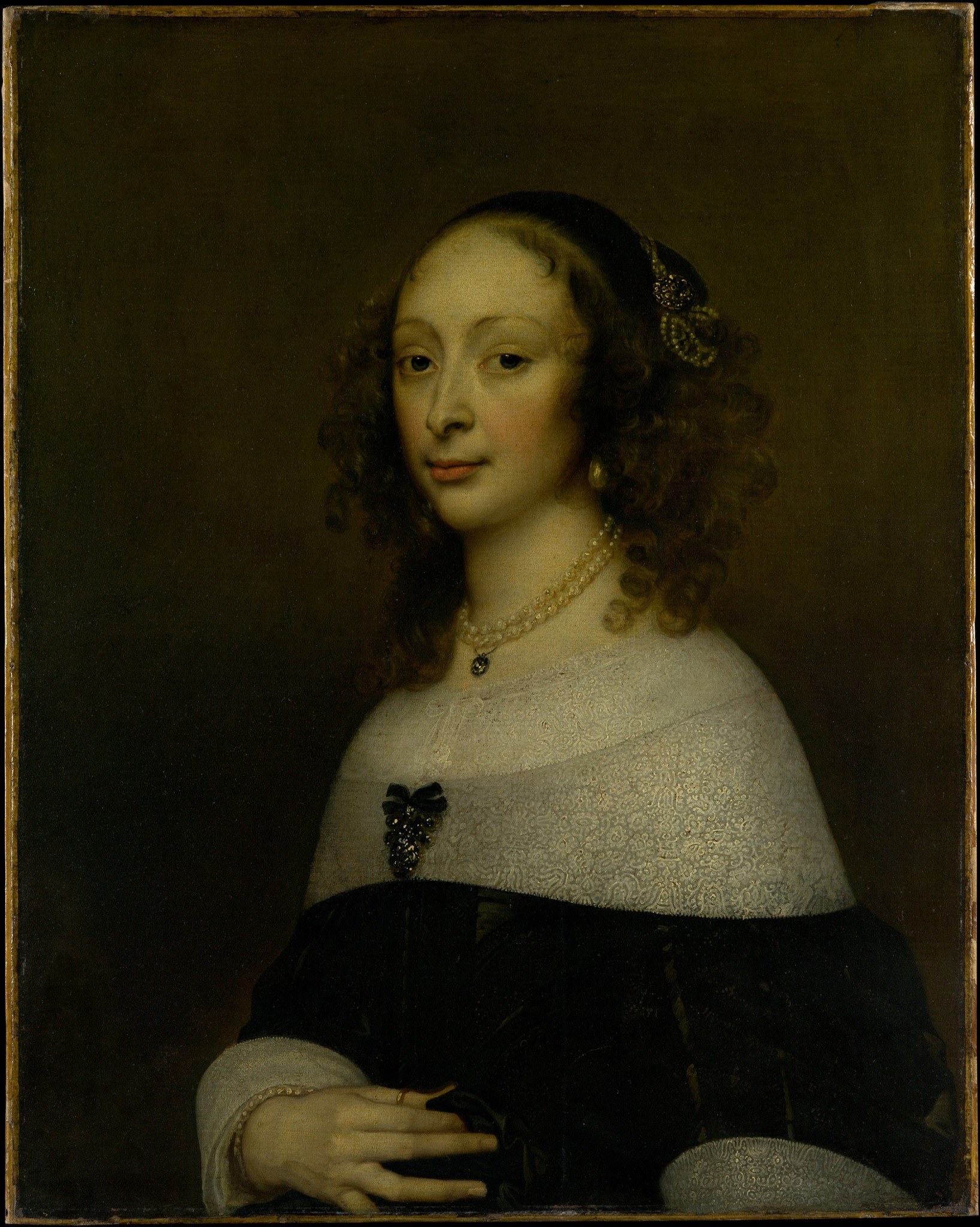 The deep, almost featureless background isolates the subject, focusing all attention on her presence and inner world.