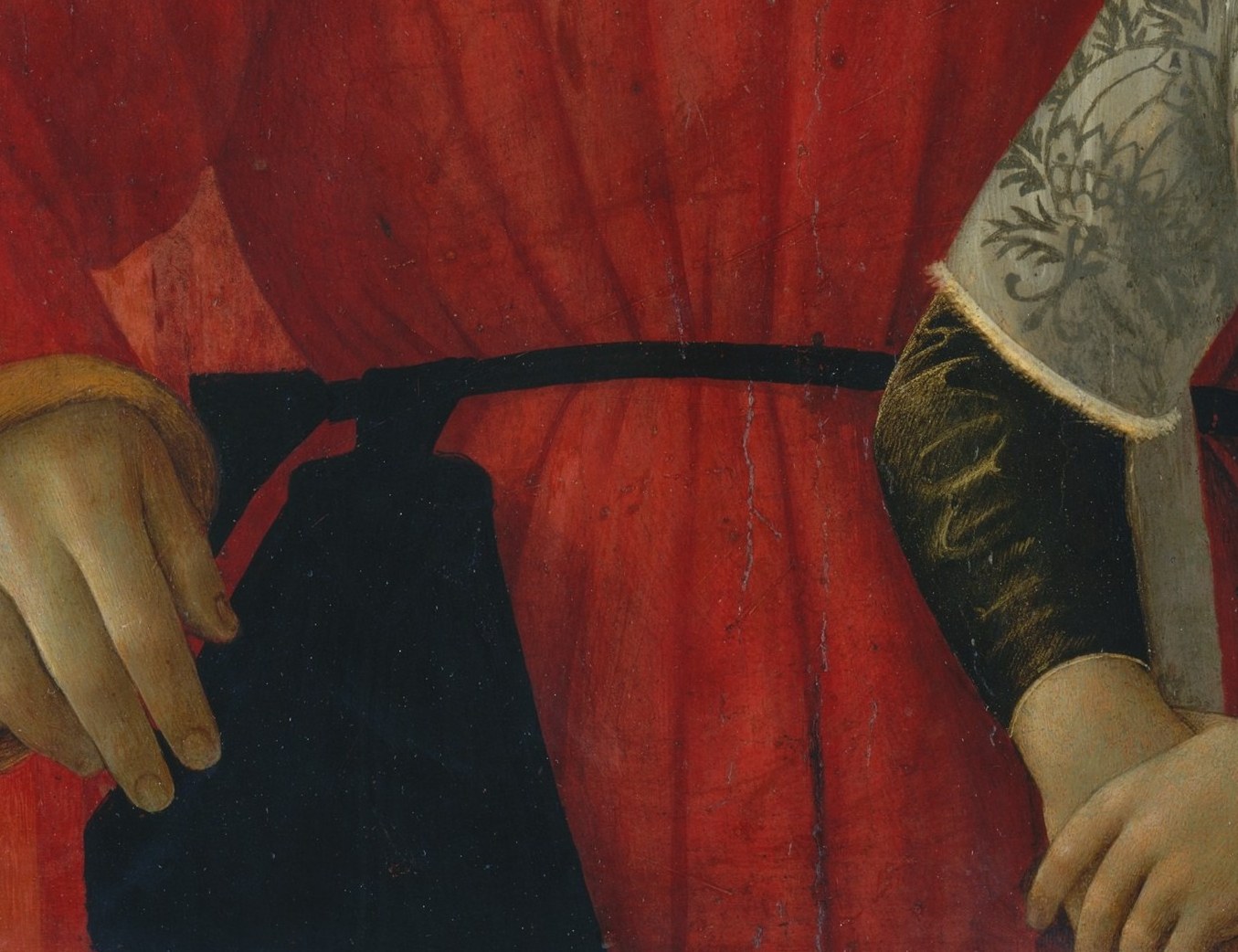 He folds his hands without an object, a mark of sober gravitas.