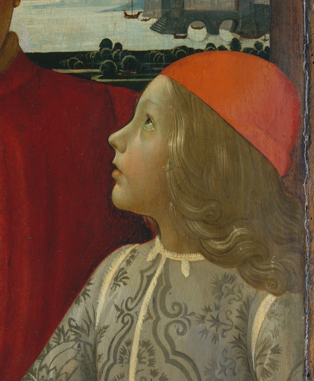 The boy looks up toward his father , a posture of deference and filial devotion that encodes the dynastic message of the commission without a single word.