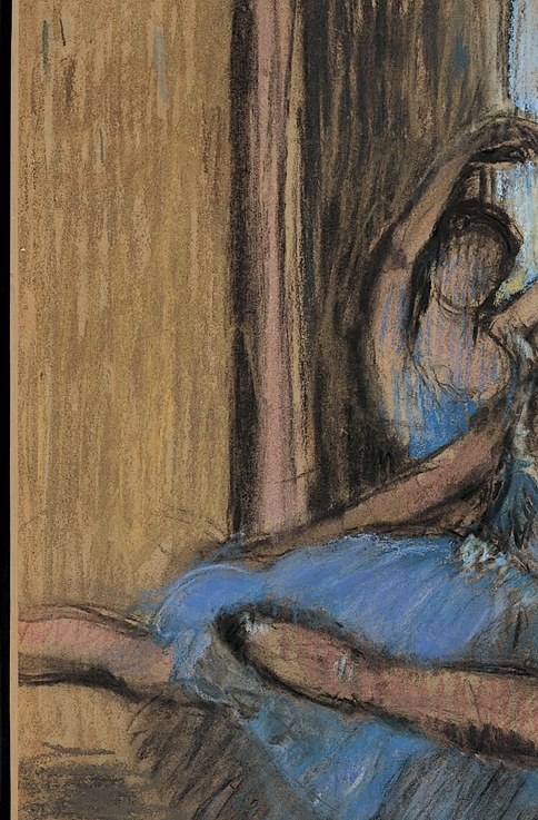 Here, a dancer adjusts her hair, caught in thought.